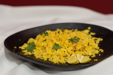 Traditional western Indian breakfast using rice flakes (flattened rice) called Aloo Pohe