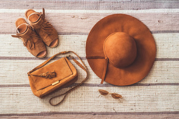 Beige sandals, handbag, glasses and hat. Top view