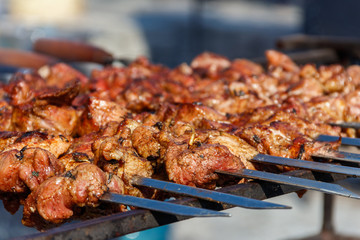 Grilled kebab cooking on metal skewer. Roasted meat cooked at barbecue