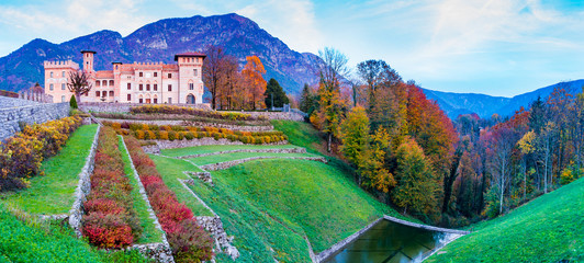 Ceconi Castle in an autumnal landscape at sunset
