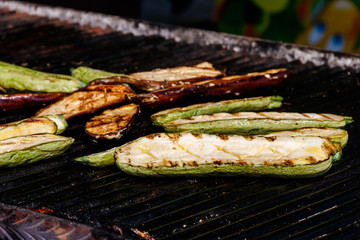 Zucchini and eggplants cooking on the grill