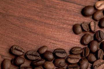 Cafe design, pictures for bars and cafes. Closeup coffee grains on burlap and brown background.
