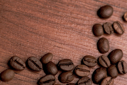 Cafe design, pictures for bars and cafes. Closeup coffee grains on burlap and brown background.