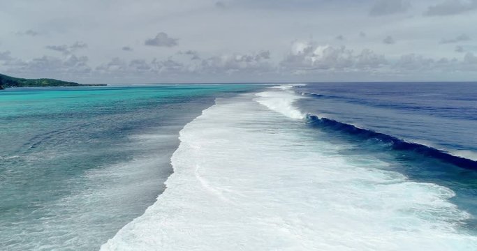 barrier with wave in a lagoon in aerial view, french polynesia
