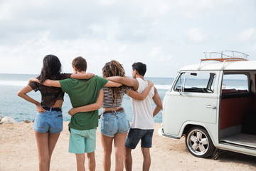 back view putting arms on friend shoulders front vintage van