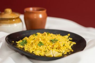 Traditional western Indian breakfast using rice flakes (flattened rice) called Aloo Pohe