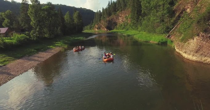 Epic Rafting Two Orange Boat on Shallow Mountain Forest Zilim River in Ural Mountains, Russia at summer sunny day - Aerial view