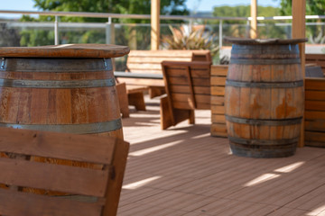 View of outdoor bar terrace, rustic wood, wooden barrels