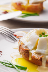 Breakfast is Eggs Benedict - toasted English muffins, bacon, ham, poached eggs, herbs and delicious buttery hollandaise sauce.