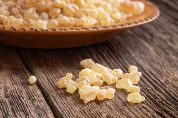 Frankincense resin crystals on a rustic background