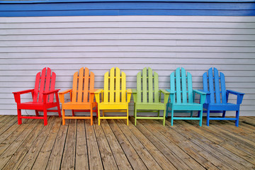 Various coloured wooden chairs 