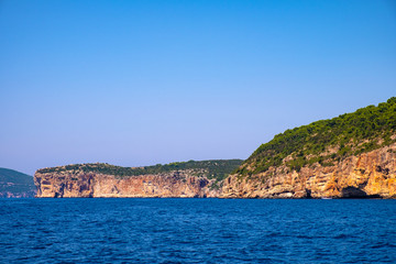 Fototapeta na wymiar Alghero, Sardinia, Italy - Faro di Capo Caccia lighthouse at the limestone cliffs of the Capo Caccia cape at the Gulf of Alghero