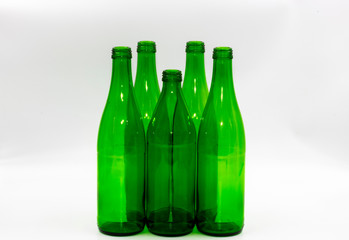 Colored empty glass bottles on white background