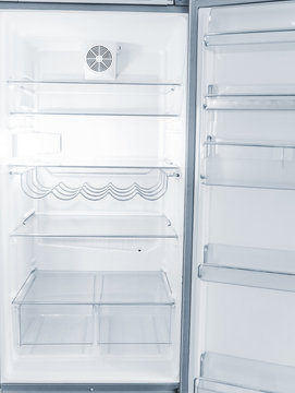 Empty Open Fridge With Shelves In The Kitchen At Night