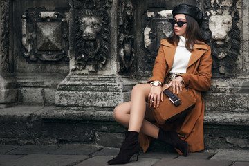 Outdoor full body fashion portrait of  elegant woman wearing glasses, beret, wrist watch, ...