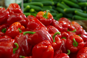 Vegetables on the counter in the store. Peppers and cucumbers