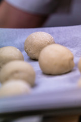 Small Bread Dough Balls Placed on Cooking Paper on Pan - Ready to be Baked