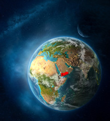 Obraz na płótnie Canvas Yemen from space on Earth surrounded by space with Moon and Milky Way. Detailed planet surface with city lights and clouds.