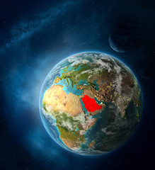 Saudi Arabia from space on Earth surrounded by space with Moon and Milky Way. Detailed planet surface with city lights and clouds.