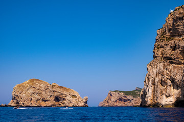 Fototapeta na wymiar Alghero, Sardinia, Italy - Rocky islands and limestone cliffs of the Capo Caccia cape at the Gulf of Alghero