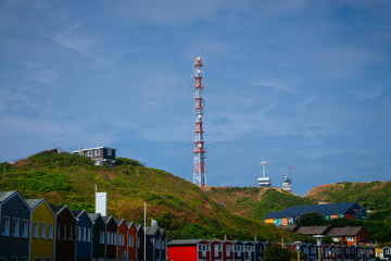 A radio tower on the hills in front of the Hummerbuden of Helgoland Germany in the north sea. 