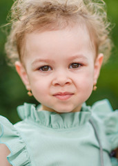 portrait of little girl outdoors in summer