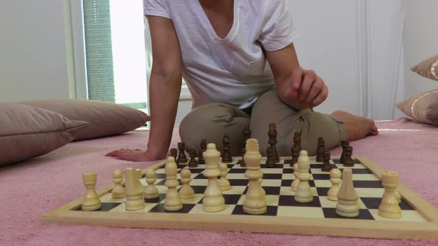 Woman is practicing in a chess game