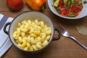 pasta and vegetable salad on a wooden table