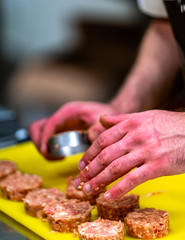 Male Chef Making Round Pork Cutlet for Some Burgers for  Wedding Meal