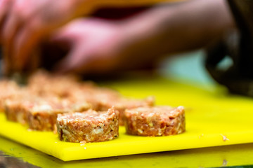 Male Chef Making Round Pork Cutlet for Some Burgers for  Wedding Meal