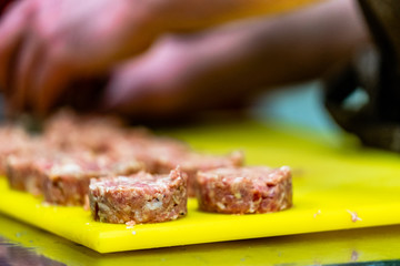 Male Chef Making Round Pork Cutlet for Some Burgers for  Wedding Meal