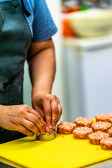 Female Chef Making Round Pork Cutlet for Some Burgers for  Wedding Meal