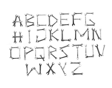 Alfabet letters written with metal wrench tools. Flat lay view.