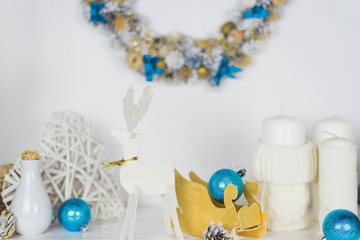 family holiday concept. Merry Christmas and Happy Holidays. Studio with Christmas decor. Winter home decor. Christmas tree, fireplace with firewood Boxes with gifts and golden and blue bows. Xmas