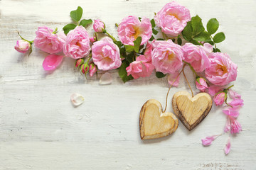 Roses with heart  on wooden background 