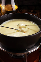 Gourmet Swiss fondue dinner on a winter evening with assorted cheese