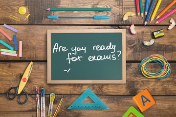 Little blackboard and school supplies on  background