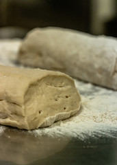 Pile of Homemade Bread Dought on a Table with a lot of Flour Around it