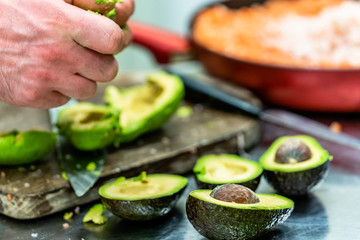 Male Chef Pealing Avocado for  Wedding Meal