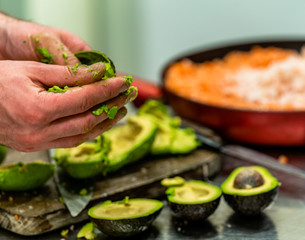 Male Chef Pealing Avocado for  Wedding Meal