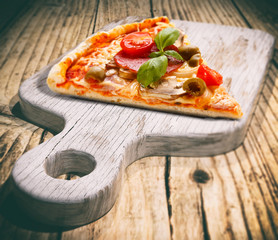 Pizza margherita and wooden old cutting board 