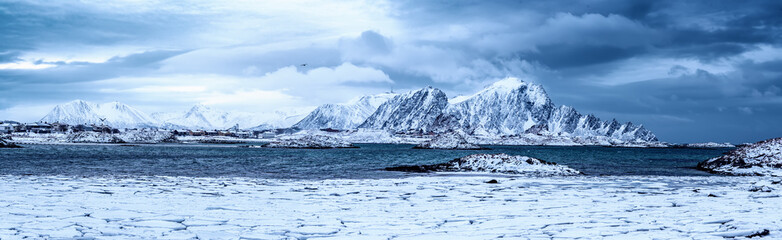 Fototapeta na wymiar Landscape with beautiful winter sea and snowy mountains at Lofoten Islands in Northern Norway. Panoramic view