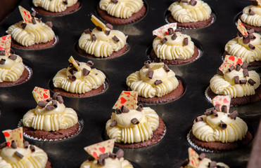 cupcakes with cream and chocolate in the baking tin