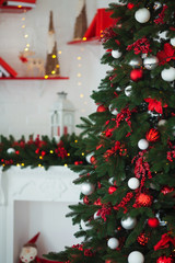 Interior room decorated in Christmas style. No people. Home comfort of modern house. Xmas tree and fireplace