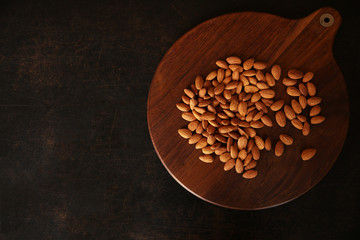 sweet almond on brown wooden background With copy space for text or image. Top view. Flat lay.