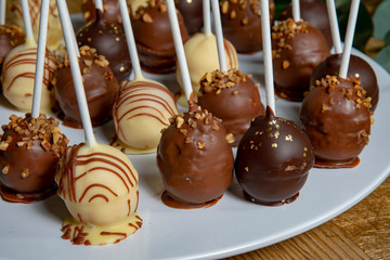 popcakes in white brown and dark chocolate