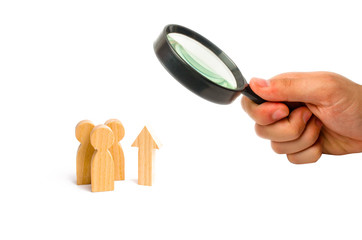 Magnifying glass is looking at a group of people and an up arrow. Increase and growth, static data....