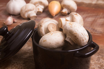 Fresh champignon mushroom in a mini pan