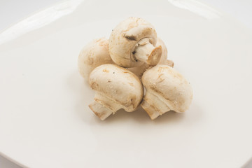 Fresh champignon mushroom on a plate