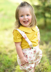 portrait of little girl outdoors in summer